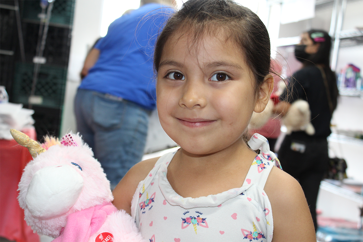little girl smiling with her unicorn